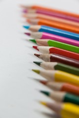 Close-up of colored pencils arranged in a row