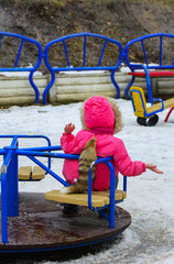 Children play on the playground in the winter on a holiday Maslenitsa