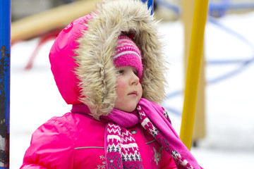 Little children play in the winter on the playground