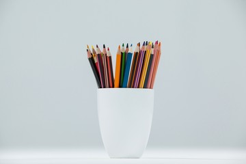 Colored pencils kept in cup - Powered by Adobe