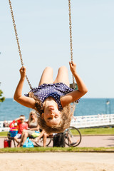 Playful crazy girl on swing.