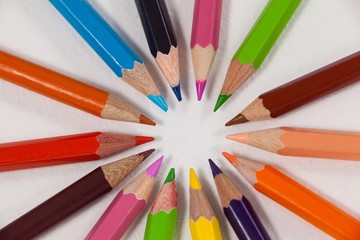 Close-up of colored pencils arranged in a circle