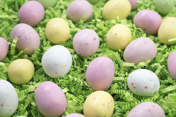 Fototapeta na wymiar Candy Easter Eggs on Bed Of Crepe Paper