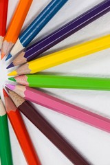 Fototapeta premium Colored pencils arranged in a semi-circle