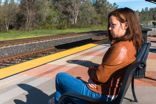Girl Sitting Near Train Rails