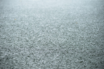 Fototapeta premium Raindrop impact on rippling water surface