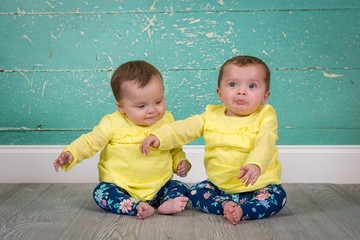 identical twin sisters in matching outfits
