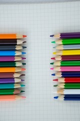 Obraz premium Colored pencils kept on the book