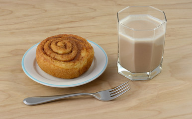 Quick breakfast of cinnamon roll and chocolate kefir milk