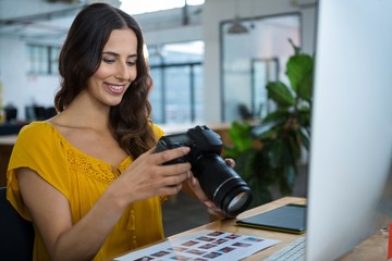 Graphic designer looking at pictures in digital camera