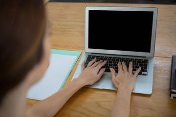 Female graphic designer using laptop