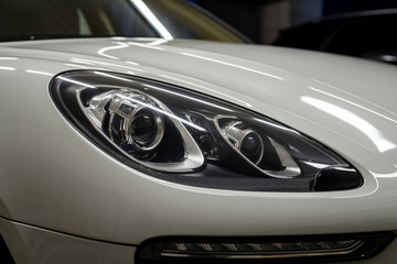 Auto headlights. Car exterior background.