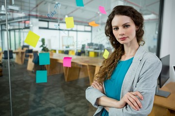 Female executive standing with arms crossed 