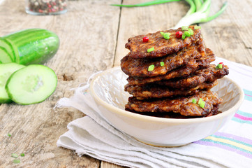 Fritters of liver.  Pancakes from the liver.  Food photo. Wooden background.