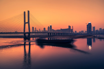 Fototapeta na wymiar sunset view of cityscape along riverside,located in China.