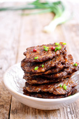 Fritters of liver.  Pancakes from the liver.  Food photo. Wooden background.