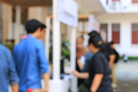 Blurred image of education people looking at the Exhibition in the university.