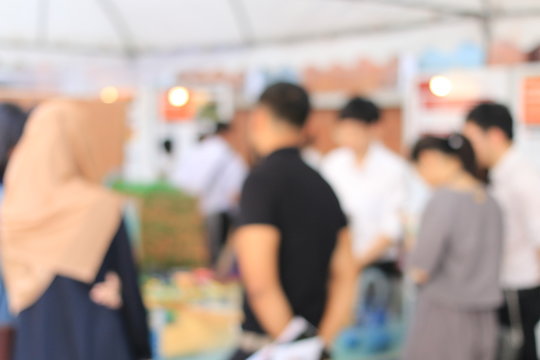 Blurred image of education people looking at the Exhibition in the university.