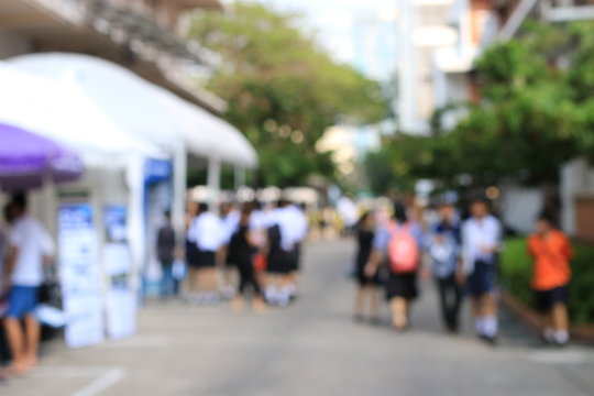Blurred image of education people looking at the Exhibition in the university.