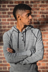 Obraz premium A young, black hipster poses for a candid photograph in NYC