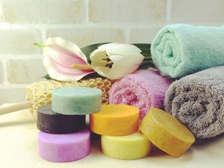 fruit soap and colorful bath towels spa and healthy background