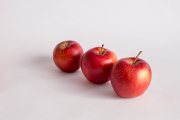 Red and green apples on a white background