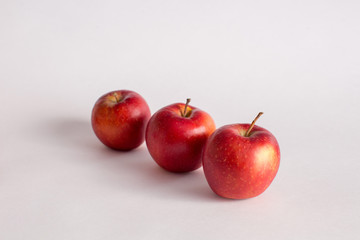Red and green apples on a white background