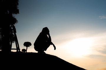 silhouette of woman Looking for a concept at sunset