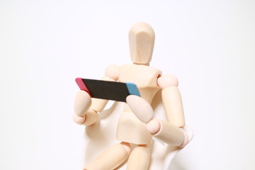 Wood mannequin playing a game on white background