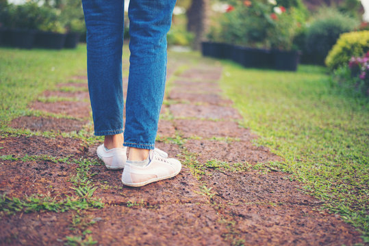 woman walking on the park at sunset.