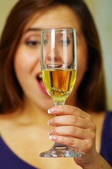 Beautiful girl holding glass with ring inside