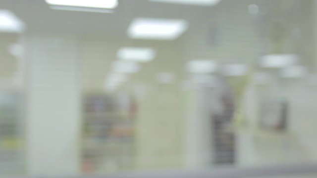 Blurred bright modern office, people walking, generic background. Intentionally defocused office
