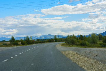 Mountain road. The landscape of fields and mountains