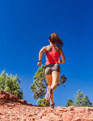 Woman Trail Running Outside Uphill