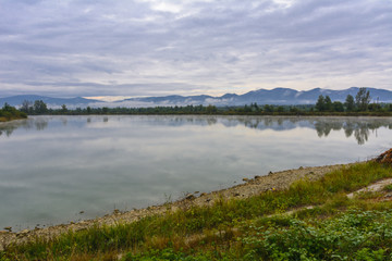 Fototapeta na wymiar Lake in the mountains for recreation and fishing. Early morning