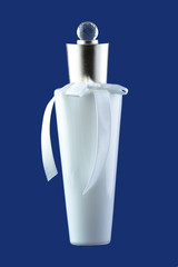 White ceramic bottle with perfume isolated on blue 
