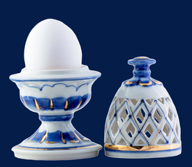 Ceramic egg isolated on blue 