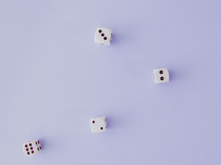 White cubic dices lying on a violet background.