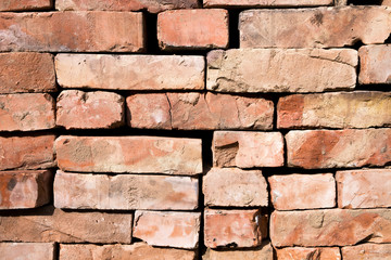 Obraz premium Red brick wall background with copy space. Used Rustic Bricks Piled.