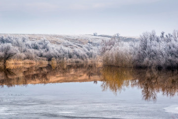 View of the lake, where the winter merges with early spring.