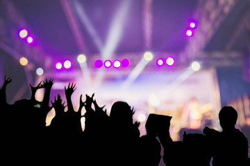 Fototapeta na wymiar silhouette audience on blurred concert stage