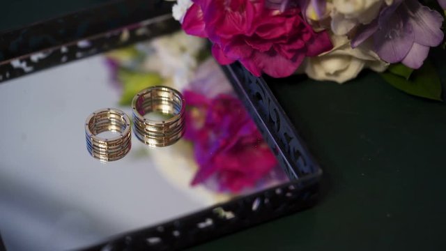 Pair of wedding rings on mirror