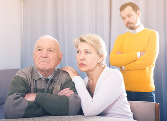 Man seriously talking with family