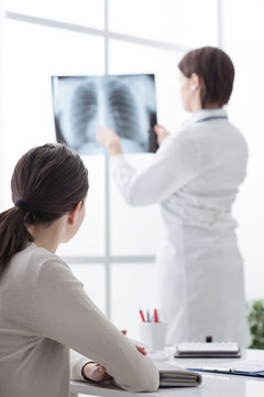 Doctor examining patient's x-ray