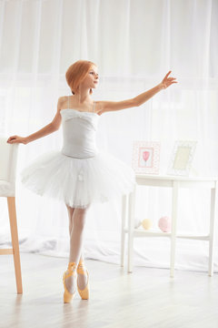 Small ballerina dancer at home