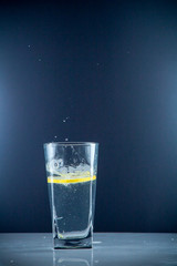 slice of lemon drops in a glass of water