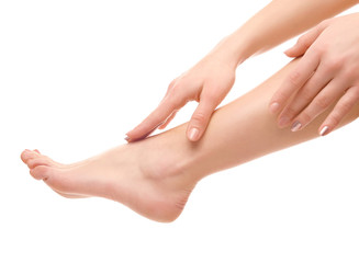 Leg and hands of young woman on white background
