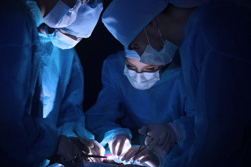 Surgeons operating patient in clinic