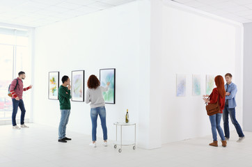 Young people in modern art gallery hall