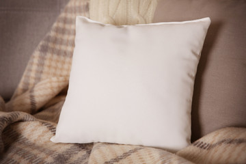 White blank pillow with space for text on sofa